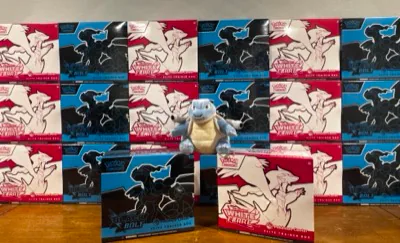 Black Bolt and White Flare Pokémon boxes arranged around a Blastoise figure