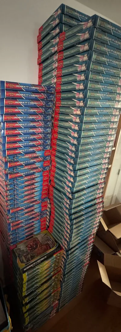 Towering stacks of Pokémon collection boxes beside open cartons