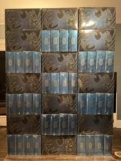 Black-and-gold Pokémon Elite Trainer Boxes arranged between rows of blue boxes