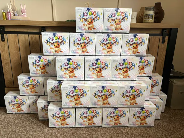 Prismatic Evolutions Elite Trainer Boxes arranged in a large pyramid.