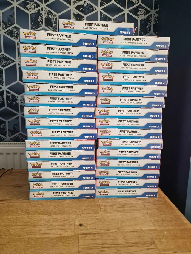 Two tall stacks of Pokémon First Partner Illustration Collection Series 3 boxes.