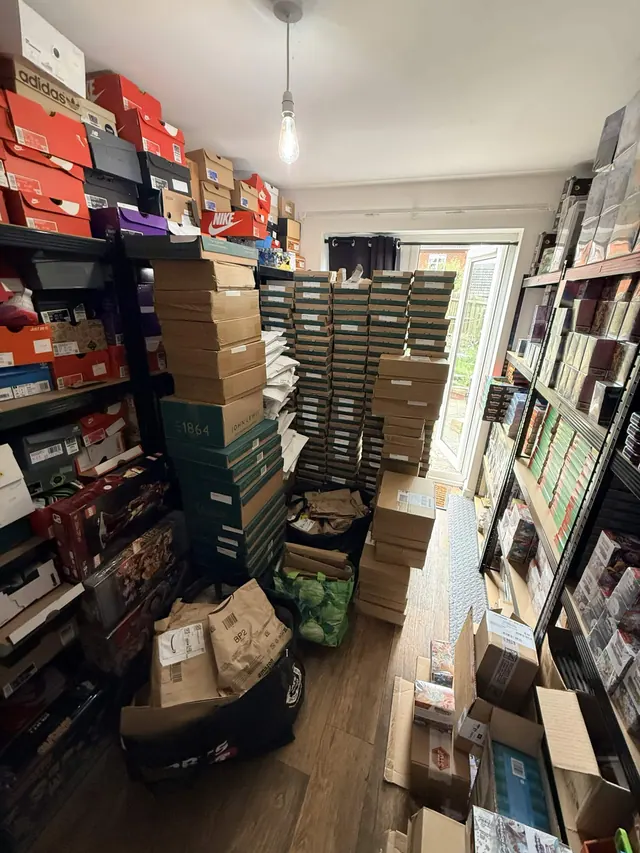 A room filled with stacked shoe boxes, Pokémon products and delivery cartons