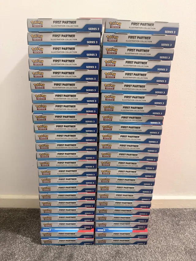 Two tall columns of blue-and-white Pokémon collection boxes against a wall
