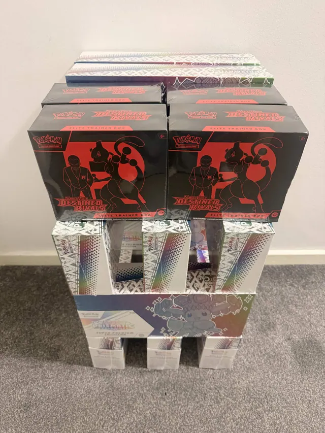 Destined Rivals boxes stacked above other sealed Pokémon collections.