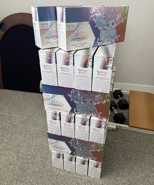 A tower of white and purple Pokémon collection boxes on a carpet