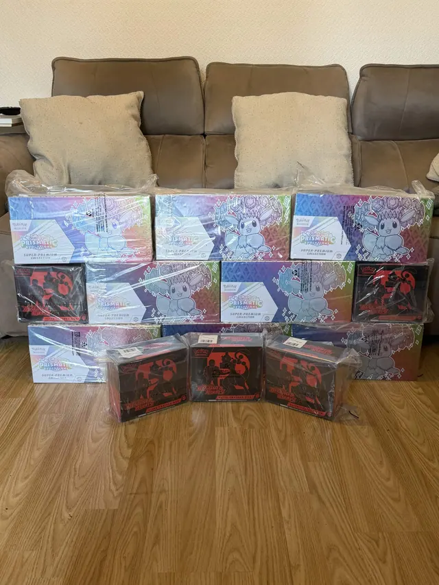 Rows of reflective Pokémon collection boxes arranged in front of a sofa