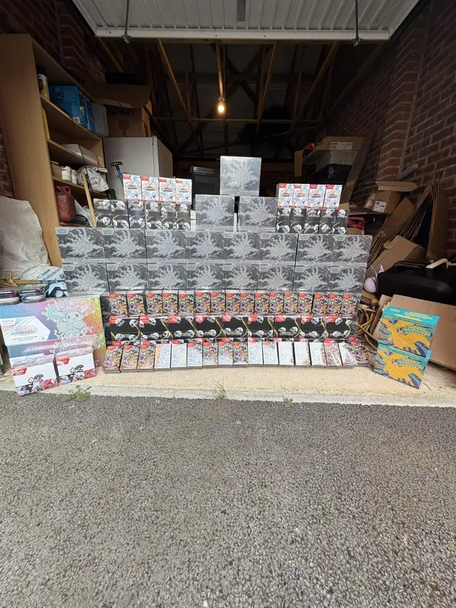 A large stepped display of Pokémon boxes in a living room.