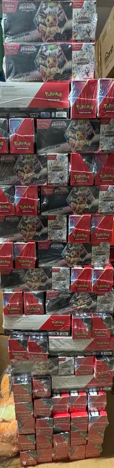 A narrow tower of assorted Pokémon collection boxes reaching up a wall.