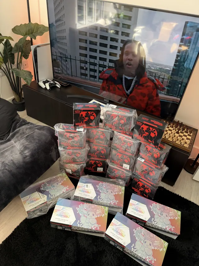 Destined Rivals Elite Trainer Boxes and Prismatic Evolutions Super-Premium Collections displayed in a living room.